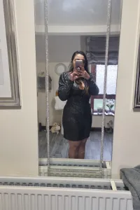 Missy K wearing a tight black dress